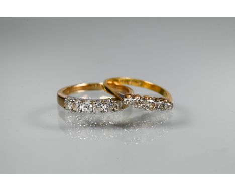 A six stone diamond ring, yellow metal (marks obscured), size P to/w a graduated five stone diamond ring set 18ct yellow gold