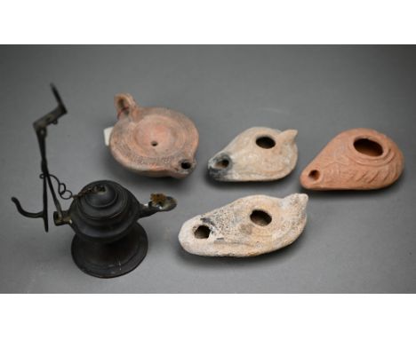 Three antiquity terracotta oil lamps to/w a later example and a reproduction metal lamp (5) 