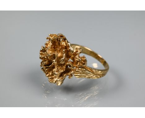 A 1970s 9ct yellow gold ring in the form of a sculptural open flower, with textured shoulders, maker HB, size T, approx 10g 