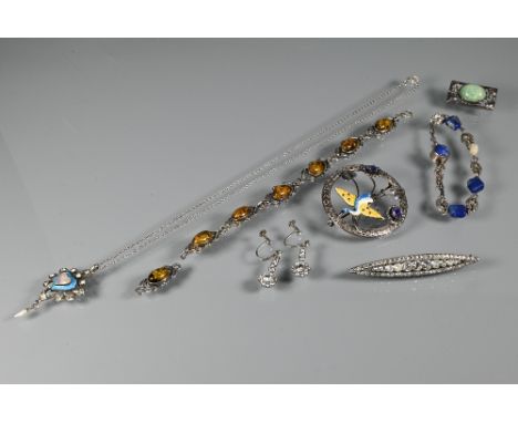 A collection of Arts &amp; Crafts jewellery including Ward Brothers open brooch featuring enameled stork and stylised flowers