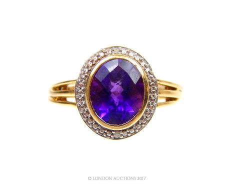 A 9 ct yellow gold on sterling silver, amethyst and diamond dress ring, the ring centrally composed of a fabulous, large, ova