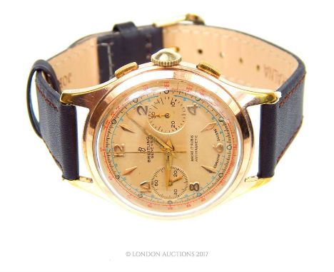 A Gentleman's, 18 ct rose gold, vintage, Breitling wristwatch composed of a gold-metal face with yellow metal Arabic numerals