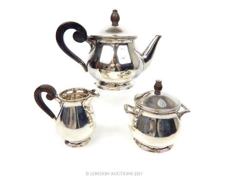 A mid 20th century Dutch silver three piece tea set, Utrecht, the milk jug and lidded sugar bowl are stamped with the 833 sta