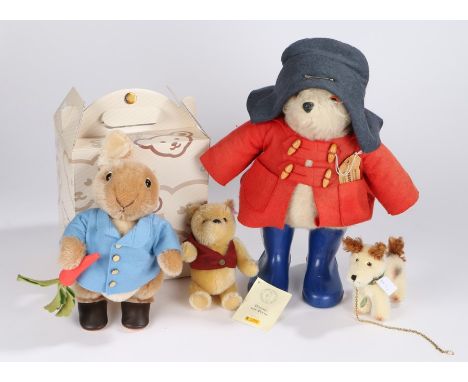 Two Steiff teddy bears, Peter Rabbit and Winnie the Pooh, together with a Hermann model dog and a Paddington bear (4)