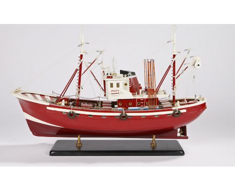 Model depicting a fishing trawler with red hull, on an ebonised plinth, 58cm long, 39cm high