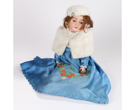 Max Handwerck Germany porcelain doll, with brown hair and closing eyes, wearing a floral embroidered faux fur edged dress and