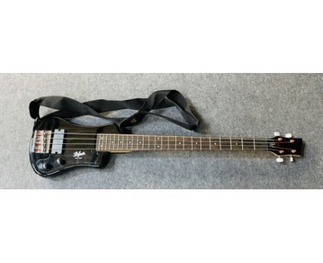 A Hofner Shorty bass guitar with soft case, in the original box, 22cms wide x 96.5cms high. Estimate £30-50.
