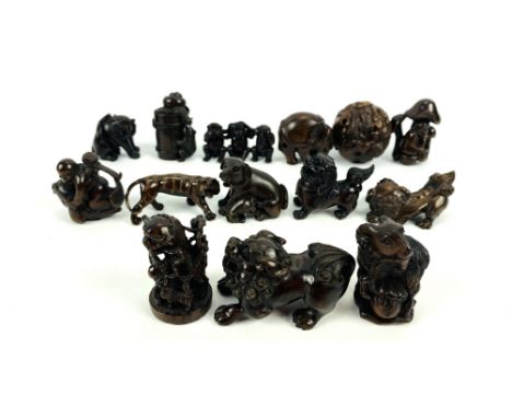 A collection of fourteen well carved hardwood Japanese netsuke, to include a zodiac ball and an elephant, 4.5cms wide x 2.5cm