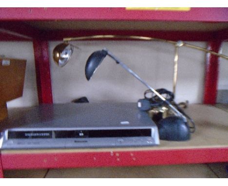 A Panasonic DVD recorder together with two angle poise table lamps on weighted bases.