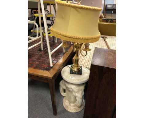 A ceramic elephant plant stand together with a brass and marble table lamp with shade.