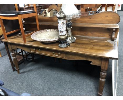 A late 19th century oversized pine hall table with shelf, fitted with a drawer.