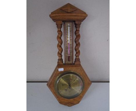 An oak barometer thermometer 