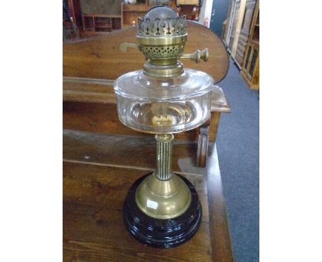A Victorian oil lamp with Corinthian column and clear glass reservoir 