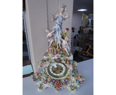 An early 20th century continental encrusted porcelain mantel clock