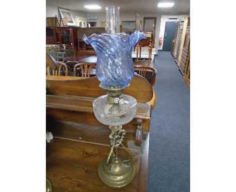 A Victorian brass and glass oil lamp with blue tinted glass shade 