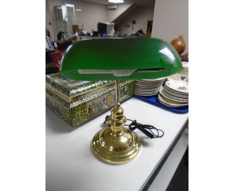 A brass banker's style desk lamp with green glass shade 