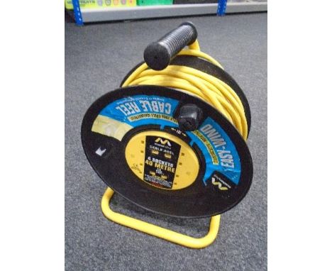 A tub containing assorted screwdrivers (new), a cased Titan belt sander and a 40 meter extension lead on reel.