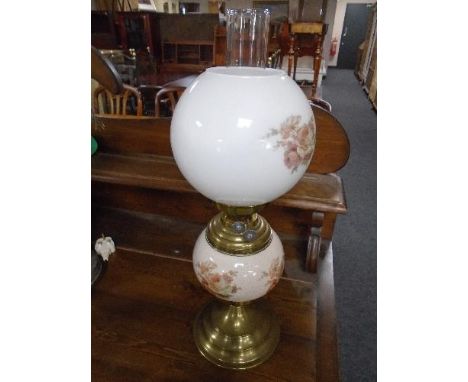 An early 20th century ceramic and brass oil lamp with white glass shade 