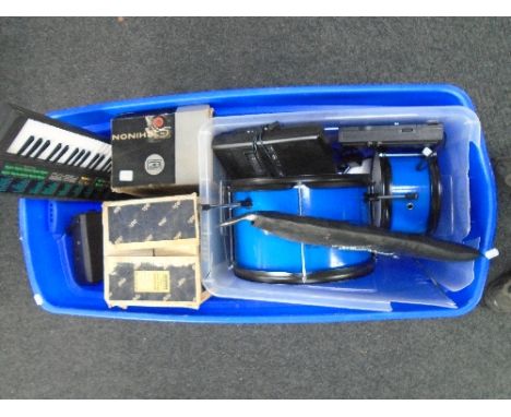 A large crate containing percussion drums by Chad Valley, electric Yamaha Voicebank PSS-170 keyboard, Aldis projector etc.