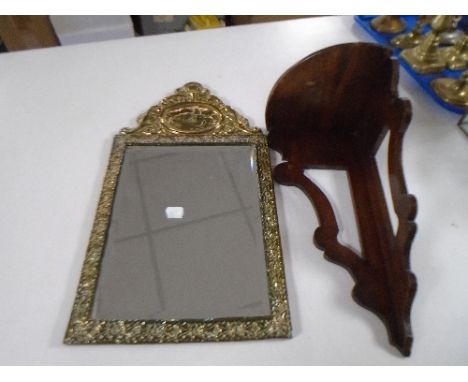A mahogany corner wall shelf together with a brass embossed framed mirror.
