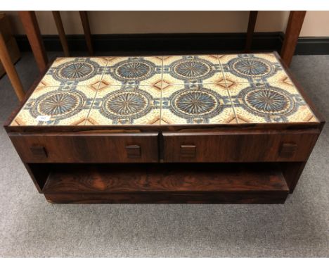 A 20th century Danish rosewood tile topped stand fitted with two drawers (length 84cm).