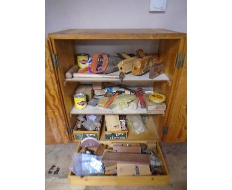 A 20th century pine double door workshop cabinet containing continental hand tools, fixtures and fittings, locks with keys, l