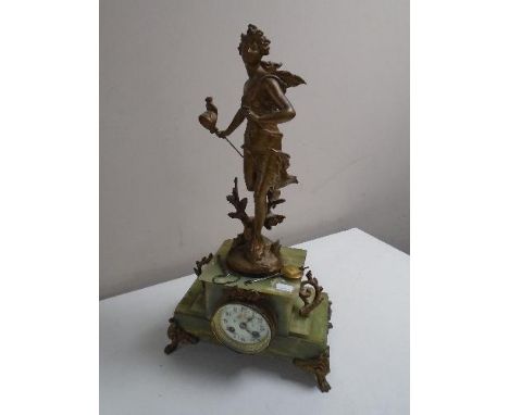 An antique French onyx mantel clock surmounted by a figure Chasse Aux Papillons Par Ferrand, with painted dial, pendulum and 