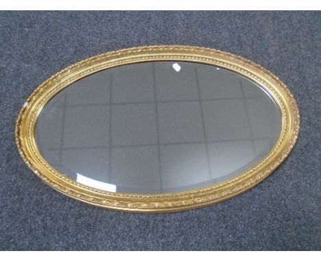 An oval framed bevelled mirror 