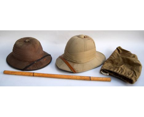 Military pith helmet with leather chin strap and sweatband, canvas cover and one other made by Cargills Ceylon and a bamboo p