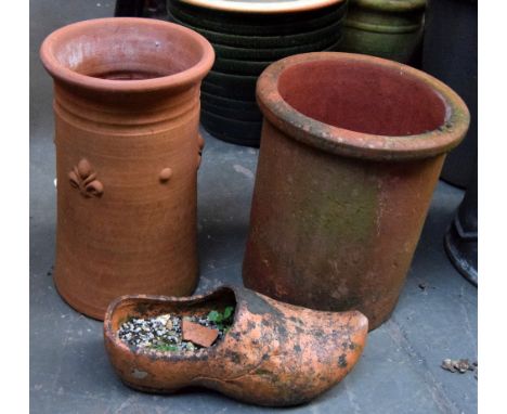 A terracota planter together with a terracotta chimney pot and clay clog