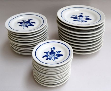 A Portuguese dinner service in blue and white to include plates, side plates, dessert plates, bowls, cups, saucers and servin