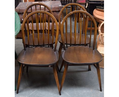 A set of four Ercol dark elm kitchen chairs with hoop back, each chair bears label to base