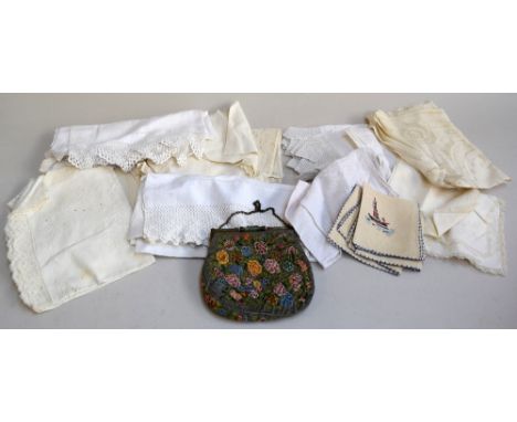 A vintage embroidered evening purse with onyx clasps and embroidered with flowers together with a quantity of linen napkins a