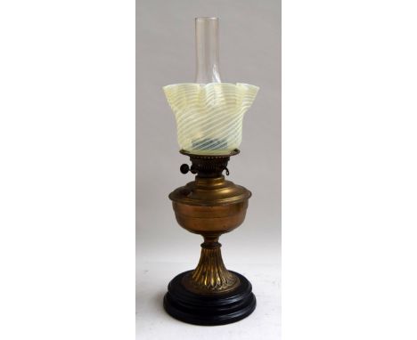 Victorian oil lamp with original chimney and  vaseline glass shade, brass resevoir on brass stand with  black pottery plinth 