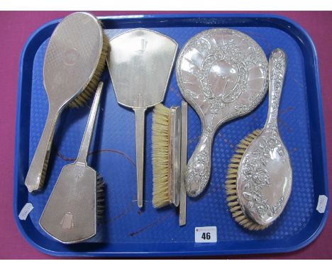 Assorted Hallmarked Silver Backed Hair Brushes and Hand Mirrors, including foliate decorated and engine turned (damages):- On