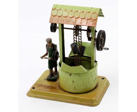 A Fleischmann early 20th century tinplate model of a model well, steam engine powered example, comprising of tin plate base w