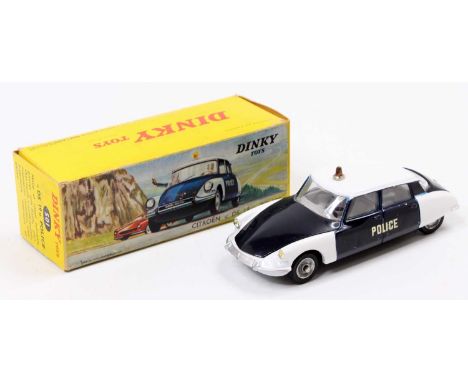 French Dinky Toys No. 501 Citroen DS 19 Police Car comprising a two-tone white and navy blue body, with a grey interior, spun