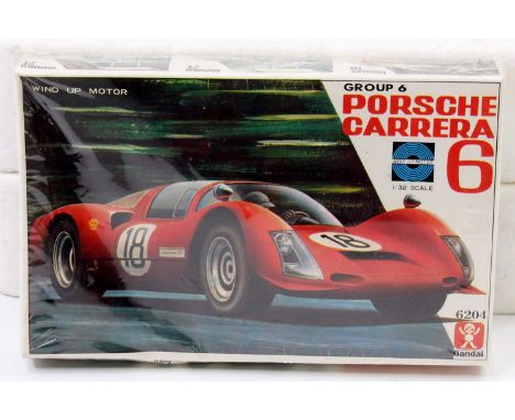 A Bandai 1/32 scale plastic kit for a Group 6 Porsche Carerra 6 housed in the original shrink wrapping