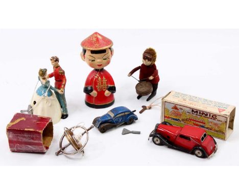 A collection of mixed novelty and tin plate children's toys to include a 1950s papier mache Chinese nodding head figurine, a 