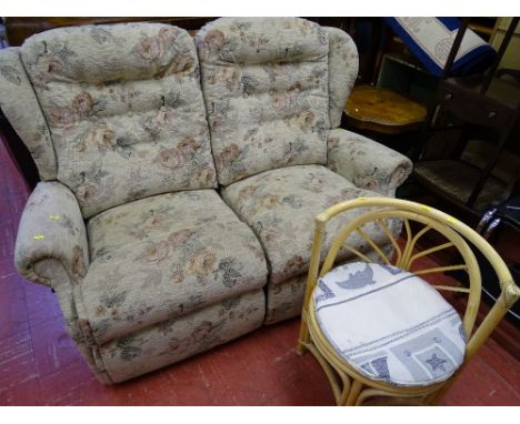 Light floral upholstered two seater couch and a single bamboo conservatory seat