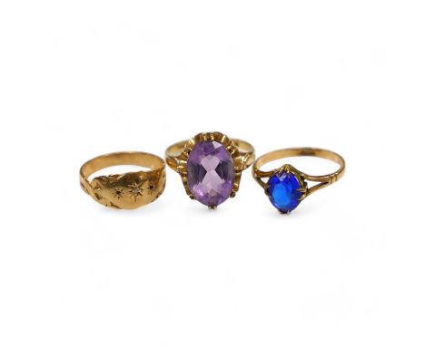 A modern 9ct gold and amethyst set dress ring, a 9ct and diamond chip set ring and a yellow metal (stamped 15c) and blue ston