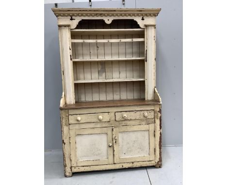An early 19th century Irish painted pine dresser with boarded rack, width 126cm, depth 49cm, height 210cm. Condition - fair S