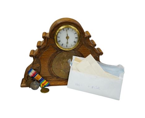 A First World War medal trio awarded to Pte. J. Ball Oxf. &amp; Bucks. L.I., together with an oak mantle clock inset with a m