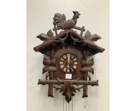 A Black Forest carved cuckoo clock, height 58cm. Condition - fair