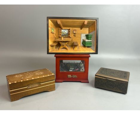 Two musical trinket boxes, a small music train decoration and a musical picture, all appear to be in working order / AN10