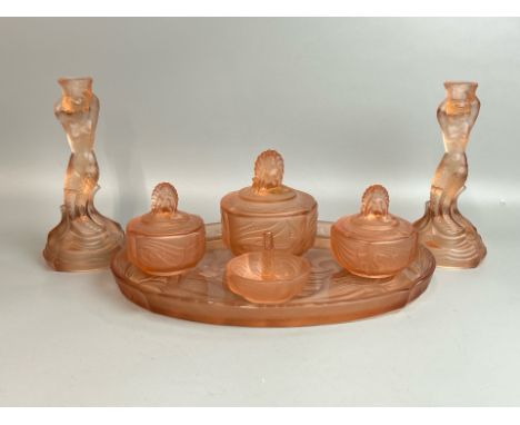 A 1930's art deco pink frosted glass vanity set comprising two candle holders, tray, three trinket boxes and ring holder, all