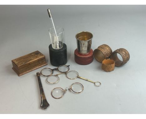 Assorted items including folding spectacles, expanding metal beaker with box, carved wood napkin rings, measuring cup and mou