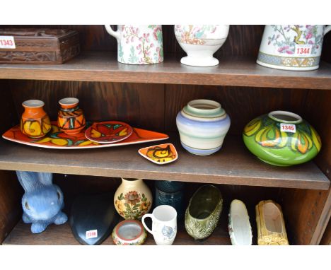 Seven items of Poole pottery.