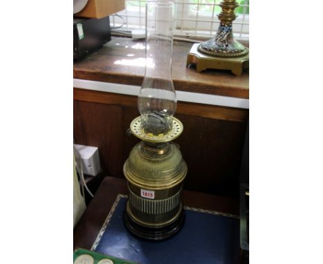 An antique brass oil lamp, height excluding chimney 31cm.  