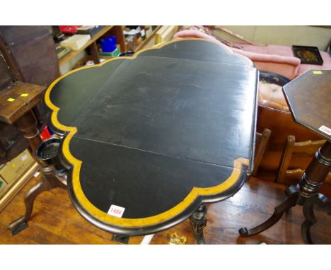 An unusual late 19th century ebonized and burr walnut crossbanded card table, of shaped outline, with four drop leaves and co